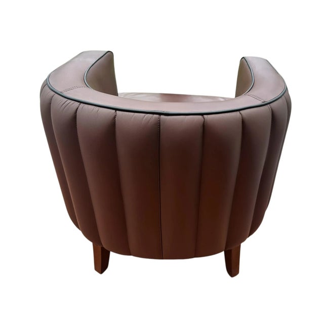 This compact cocktail chair exudes cozy elegance. Juniper impresses with its all-over ribbed leather upholstery in vintage...