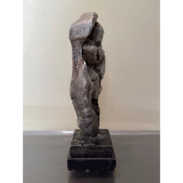 This striking mid-century modern abstract sculpture features a heavily textured, organic form that perfectly encapsulates...