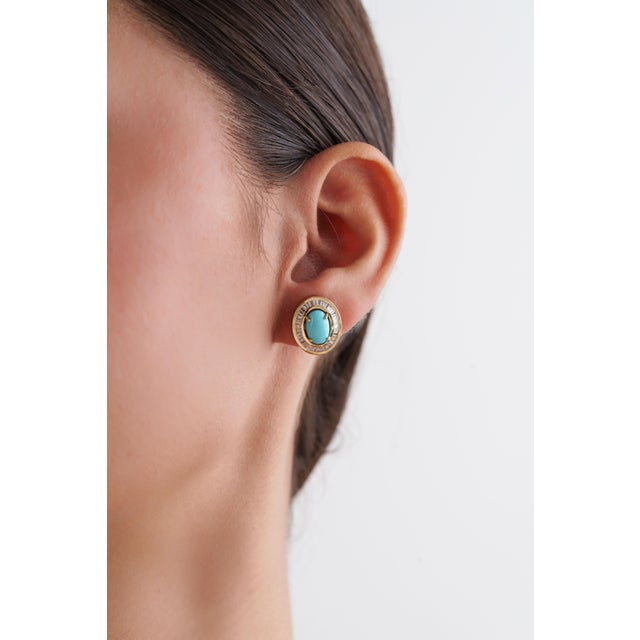 These stud earrings feature vibrant 2.42 ct turquoise cabochons, set in 14K yellow gold, Each turquoise measures 9 × 6 mm...