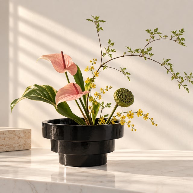 A vintage, tiered black art glass bowl, planter or vase. Good condition.