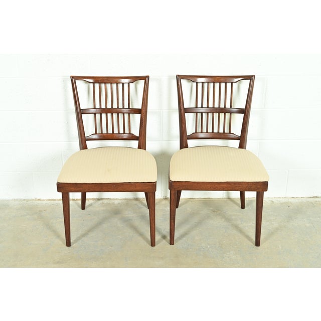 An exceptional pair of Mid-Century Modern spindle back side chairs or dining chairs In the manner of Paul McCobb USA,...