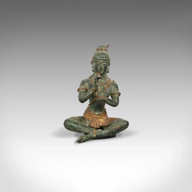 This is an antique decorative figure. An Oriental, bronze statue or study of a musician, dating to the late 19th century,...