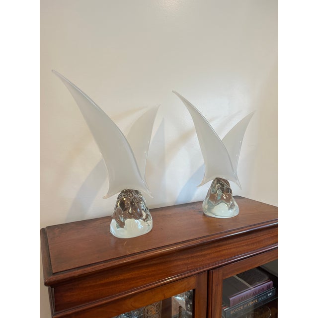 Graceful sculptures capture the beauty and freedom of seagulls in flight, with their wings elegantly outstretched....