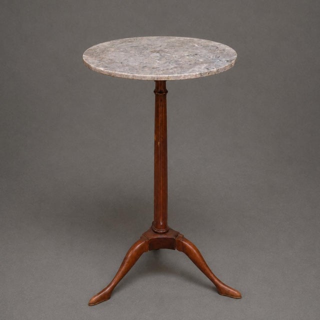 Elegant and understated, this 19th Century English tripod table pairs a richly toned mahogany base with a beautifully...