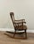 Antique, oak, early 20th century children’s rocking chair. A solid wood construction with carved details on the backrest...
