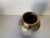 A classic example of mid century modern design; gold base with white drip overlay.