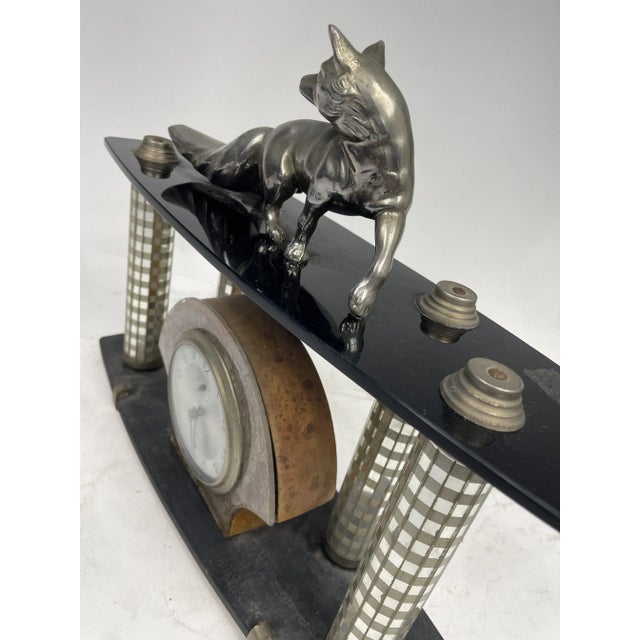 Beautiful 1920s Liberty clock, decorated with mirrored glass and metal fox on top. Excellent furnishing object. Excellent...