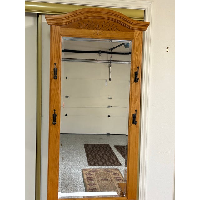 Bring classic warmth and practical organization to your foyer or mudroom with this beautifully crafted honey oak hall...