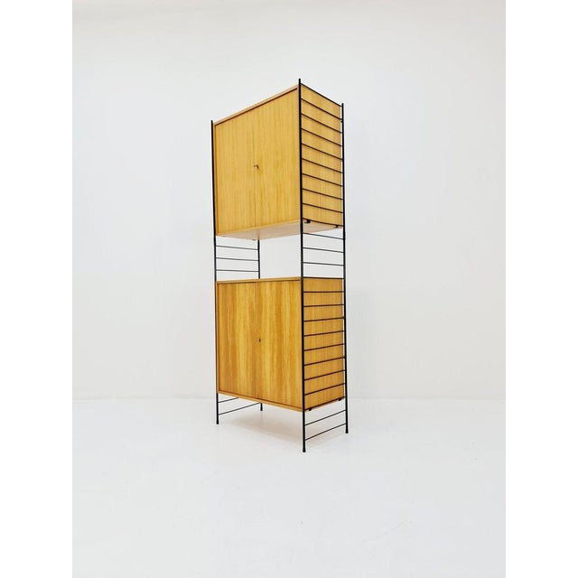 Free standing String shelf system, bookcase with cabinet Eshe by WHB Germany, 1950s The bookshelf system is in great...
