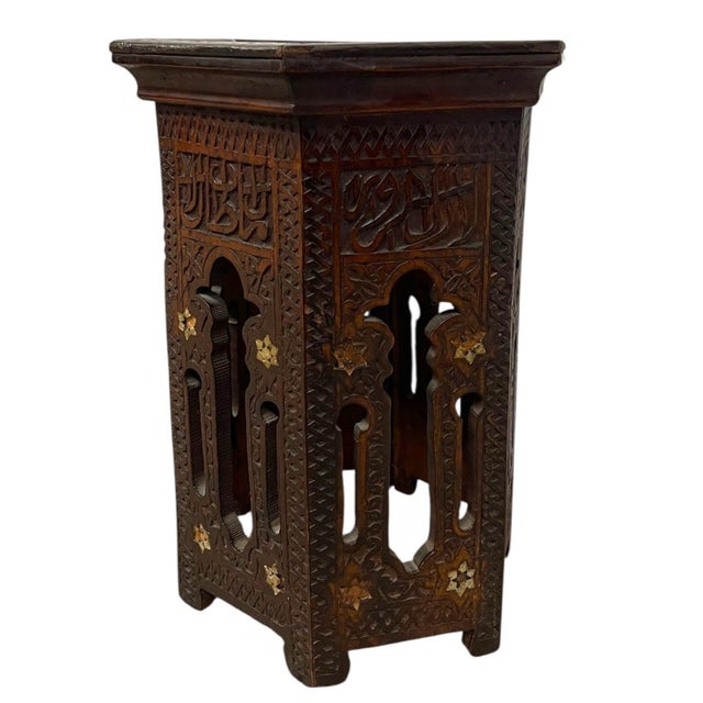 This vintage hexagonal side table features richly detailed hand-carved decoration Constructed from wood with a dark...