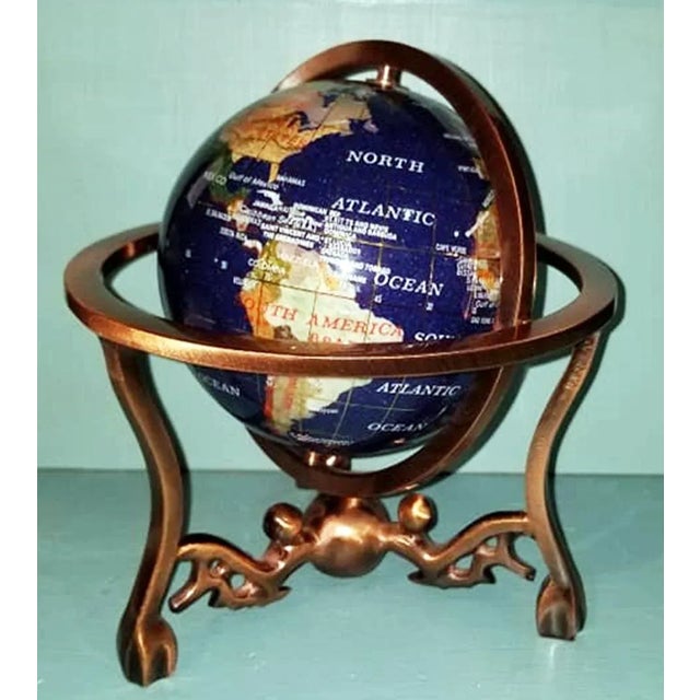 Very detailed desktop globe in a copper metal tripod created from semi precious stones set in resin, c. 1980s.