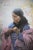 Cree Finery by Howard Terpning captures the quiet dignity of a Cree woman preparing her beaded necklaces against a softly...