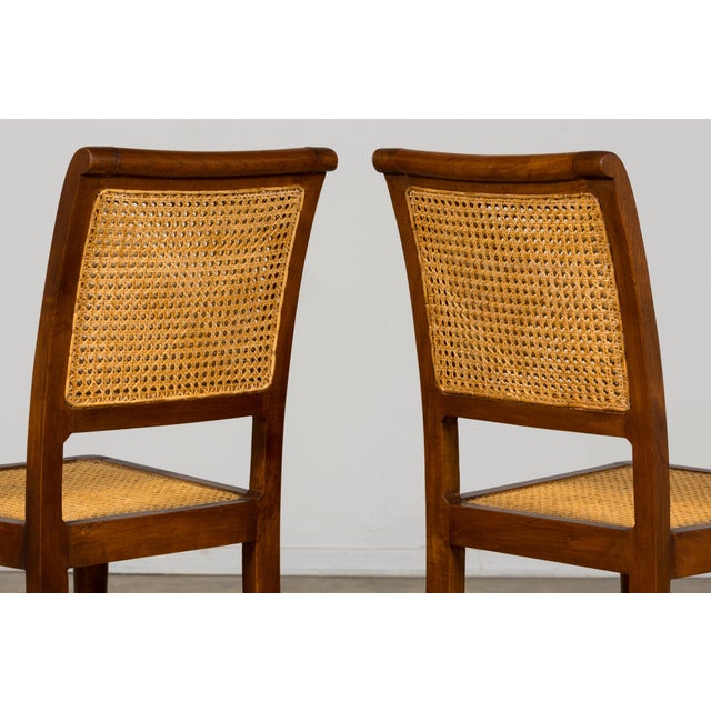 Sourced in Provence, France, this set of six French Provincial dining chairs is crafted from solid walnut and embodies the...