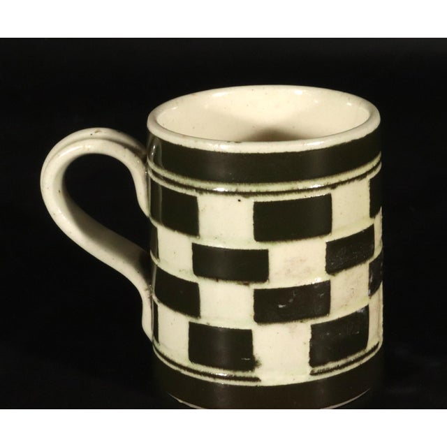 English Creamware Checkerboard Child's Mug, Circa 1820–1850 Circa 1820–1850 This English child's mug is finely potted in...