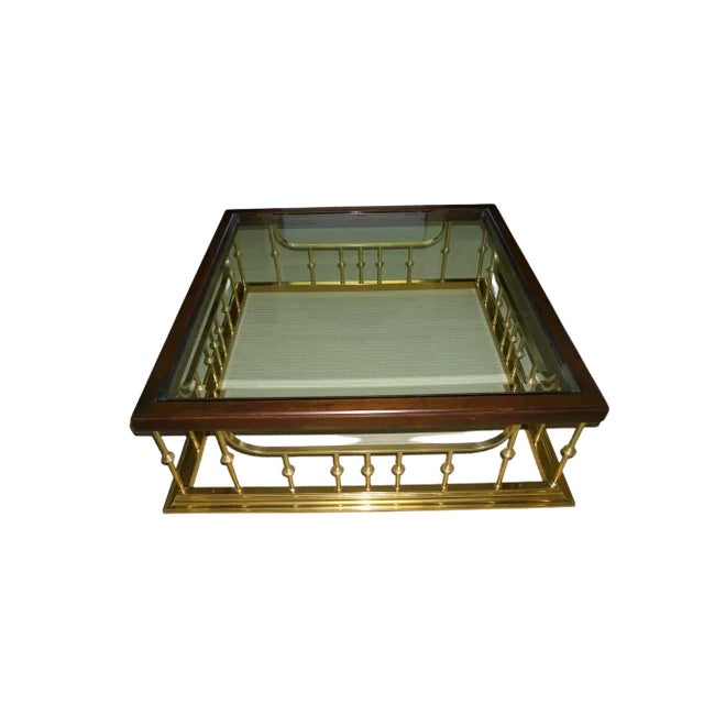 Beautiful vintage wood, glass and brass coffee table. Its unique design works well in a variety of spaces - traditional,...