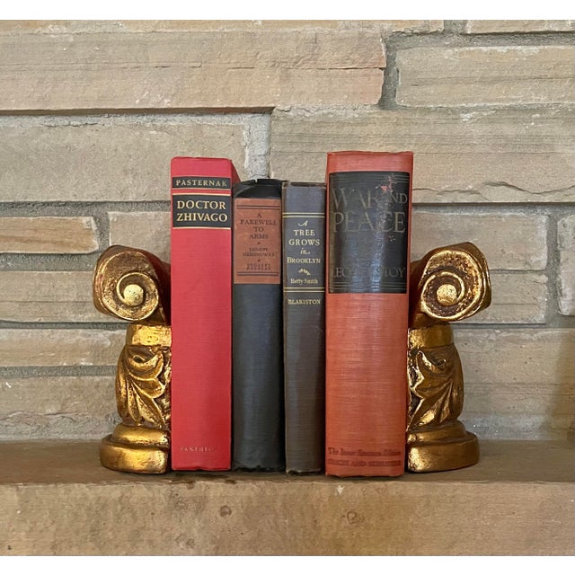 Beautiful column-form bookends feature stylized Ionic capitals and boldly carved acanthus detail. Gilded plaster is...