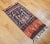 A striking vintage hand-woven Ikat textile panel from Indonesia, dating to the mid-1900s. This artisanal piece features a...
