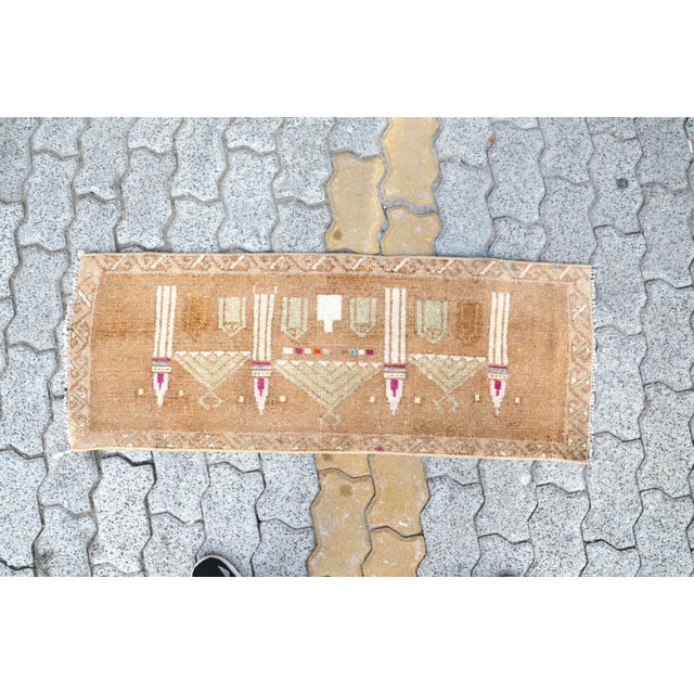 This is a vintage Turkish Oushak rug from the 1960s. The piece was hand-knotted.