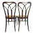 Pair of unique Bentwood Thonet Dining Chairs with cane seats. The delicate arches cross and connect at the rear loop...