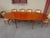 Large oval table seating 6 to 12 people thanks to the integrated extensions stored beneath the tabletop. Cherry-stained...