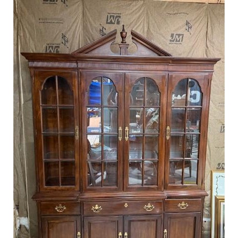Beautiful Drexel cherry breakfront china display cabinet having four glass doors opening to adjustable glass shelves; the...