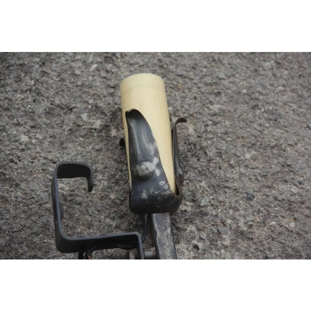 This pair of mid-century Italian wall lights is made of wrought-iron. Up to 250V (Europe/UK Standard).The wiring of this...