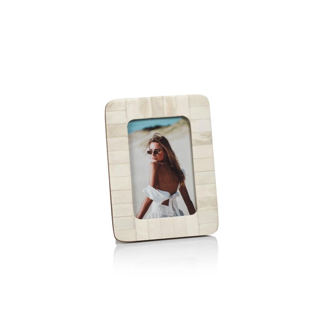 The Cote d' Ivoire Bone Inlay Photo Frame with Rounded Corner adds a touch of exotic charm and artistic flair to your...