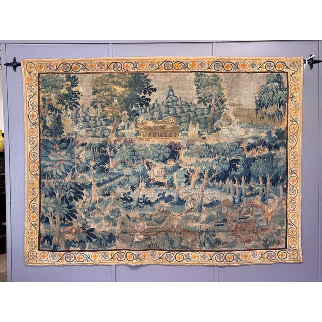 Woven late 17th century Flemish tapestry depicting a wooded landscape with hunting figures and animals in the foreground,...