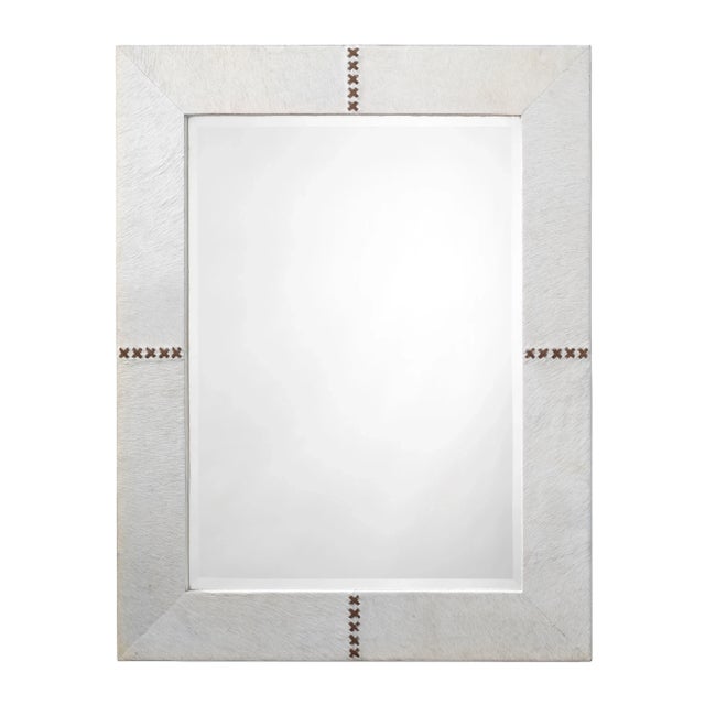 This generously sized beveled wall mirror is edged in hair-on-hide and accented with a contrasting leather cross stich....
