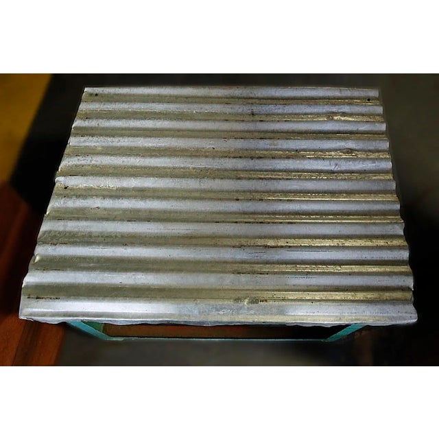 Vintage industrial iron table on wheels with corrugated metal top. One could add thick glass, marble, slate etc to the top...