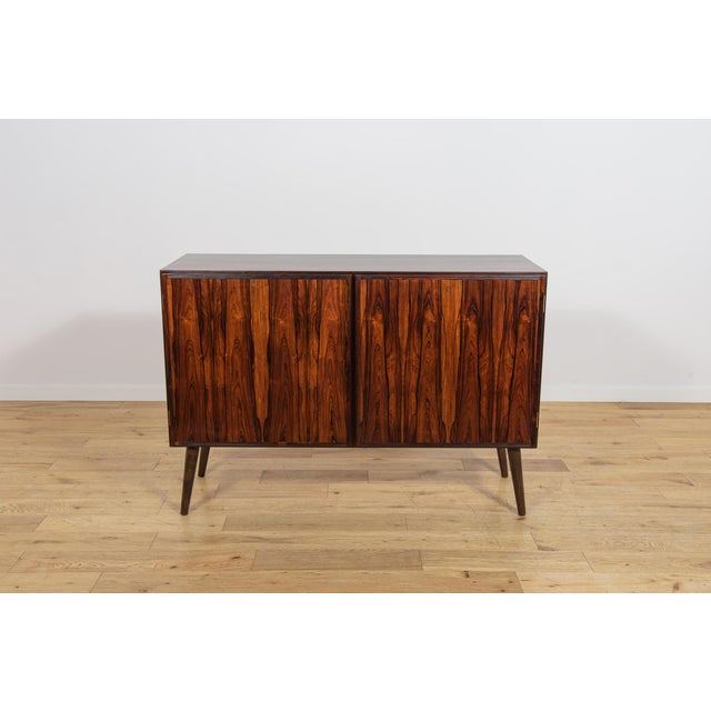 This elegant sideboard was manufactured by the Danish furniture maker Oman Jun during the 1960s. The piece is...