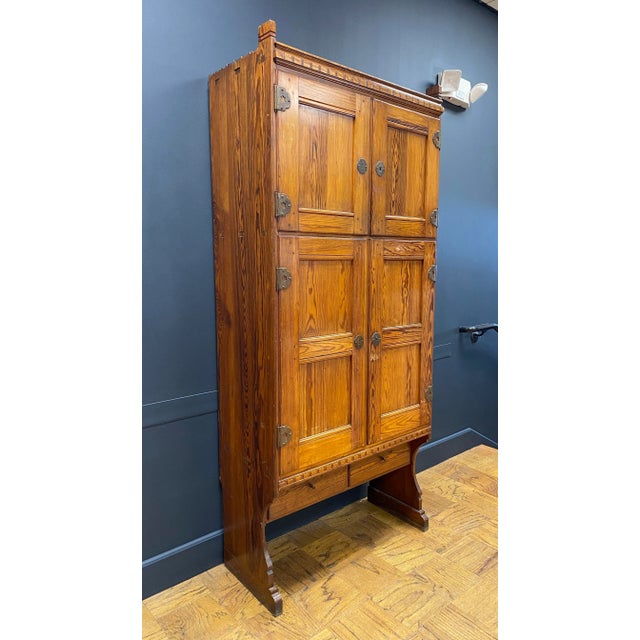 Solid pine tall cabinet by Danish Architect Martin Nyrop. Designed for the Copenhagen City Hall in 1905. Hammered metal...
