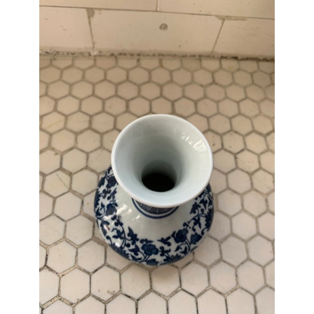 Small Chinese vases with floral blue-and-white chinoiserie transfer pattern. Artist stamp on underside.