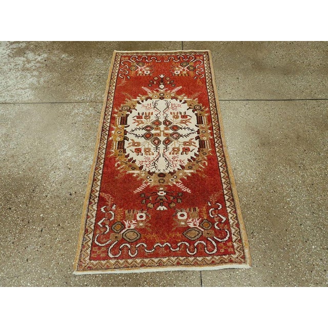 A vintage Turkish Oushak throw rug. The ribbon cloud band corners position ivory and grass green central oval medallion on...