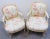 Louis XV Style Upholstered Armchairs - A Pair. Distressed cream painted carved frame with floral upholstery.