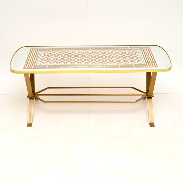 A stylish and interesting vintage coffee table, made in England and dating from the 1970’s. This has a mirrored top with...