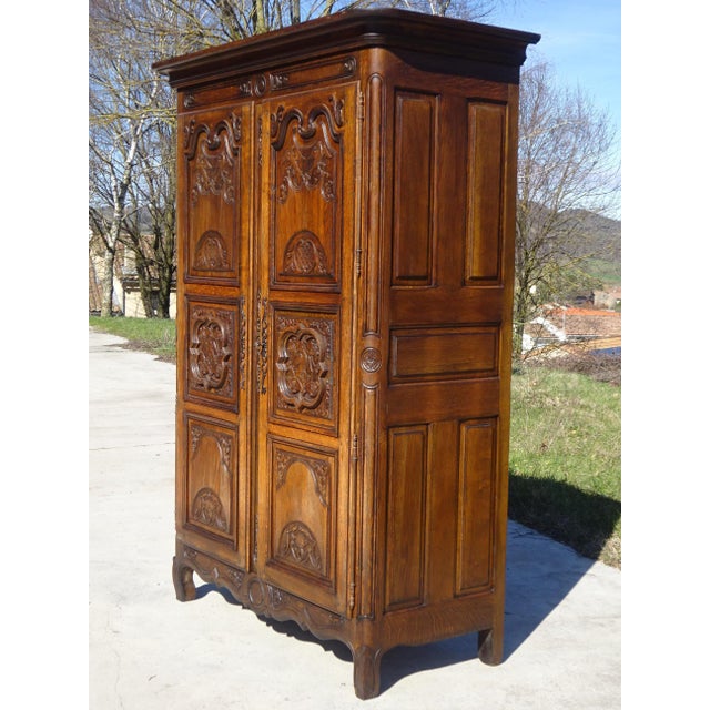 An imposing oak wardrobe, beautifully crafted in France, mid-20th century. Numerous carved motifs with pronounced relief...