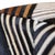 "A bold interplay of pattern, contrast, and craftsmanship, this handmade cowhide leather pouf is designed to command...