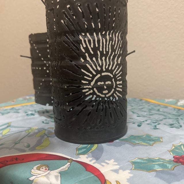 This striking mid-century style pierced tin lantern showcases a captivating brutalist aesthetic with its deeply textured,...