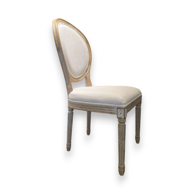 A set of four balloon back chairs by Restoration Hardware in the Louis XVI style. Note: these chairs are grey / white. See...