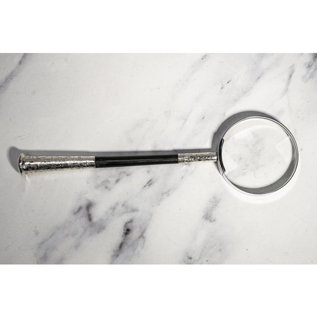 A sophisticated marriage of antique craftsmanship and modern function, this luxury magnifying glass has been thoughtfully...