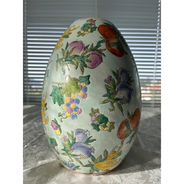 Enhance your home with this stunning vintage Chinese Famille Rose porcelain egg-shaped vase. This substantial piece stands...