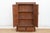 This 57-inch tall antique cabinet is a study in colonial geometry and texture. Crafted from solid teak, it features a...