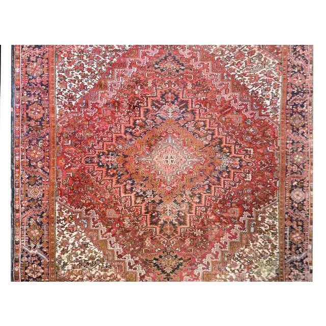 A wonderful bold late 20th century Persian Heriz rug with an incredible diamond medallion radiating with myriad floral...