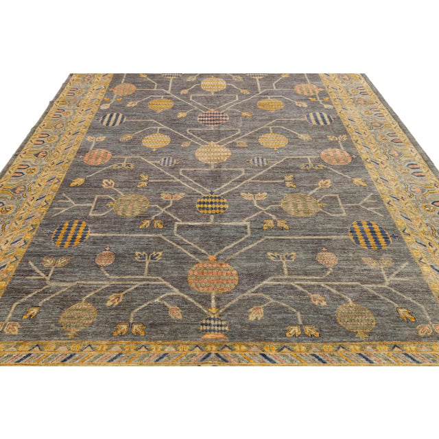 Elevate your space with this hand-knotted wool rug in the iconic Khotan style. Featuring a dark charcoal-grey field, it...