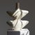 Two sharp, wing-like flanges extend outward in mirrored symmetry from this Tamegroute vase, a slender neck rising quietly...