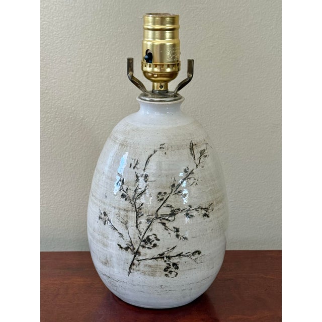 Beautiful off-white glazed studio pottery table lamp with botanical motif. Bottom is signed Hatch. Please see condition...