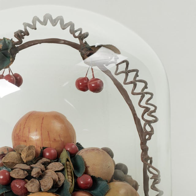 Standout 19th century English paraffin wax assemblage of fruit and nuts in a faux wicker basket, presented under a glass...