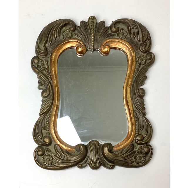 Vintage Hollywood Regency Composite Wall Mirror Measures 11 1/2” wide x 14 1/4” tall x 1/2” thick. This elegant mirror...