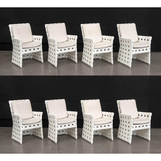 Set of Eight Skyline Design "Jamaica" Dining Chairs, woven white plastic framed with beige cushions. 34" H x 24" W x 23.5"...